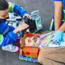 First aid, ambulance. Paramedics provide first aid to injured man with medical equipment, give