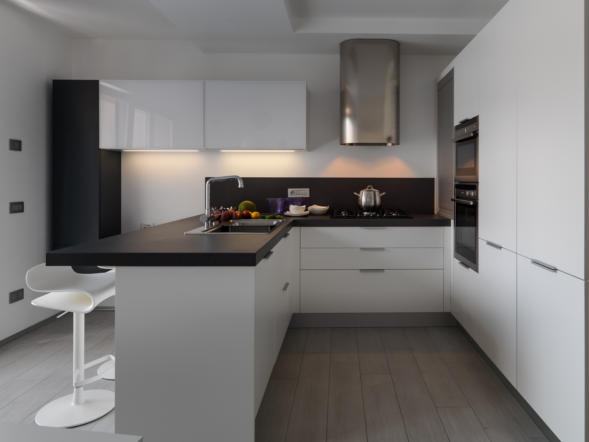 interior view of a modern kitchen with fresh fruit on the worktop near at sink