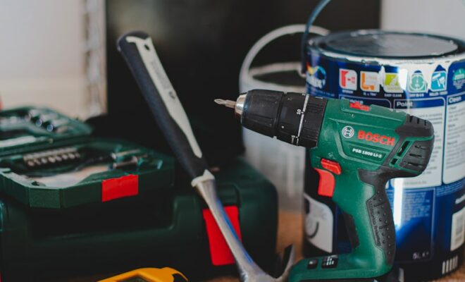 red and black cordless power drill beside black and red cordless power drill